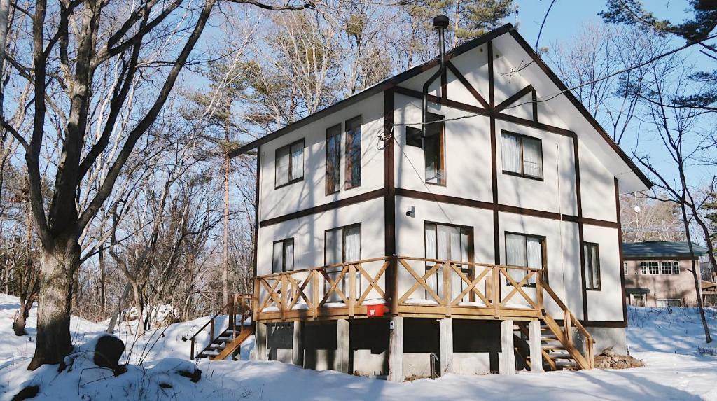 a large house in the snow in the woods at Murmure　6人家族や友人向け　ペット可 in Tsumagoi