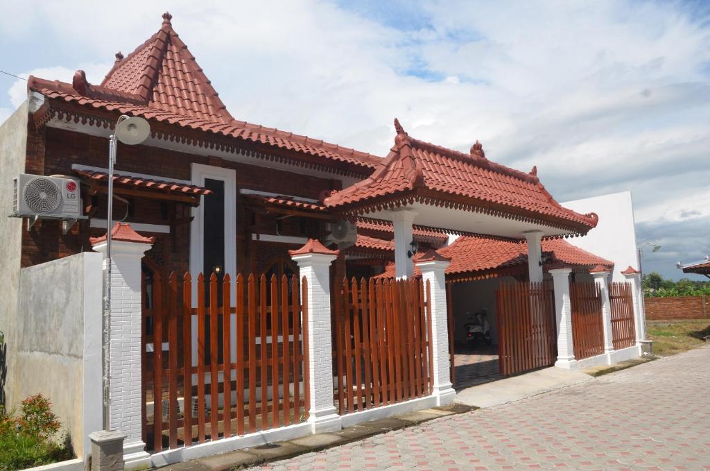 a small house with a gate and a roof at Capital O 93719 Homestay Omah Bidadari in Prambanan