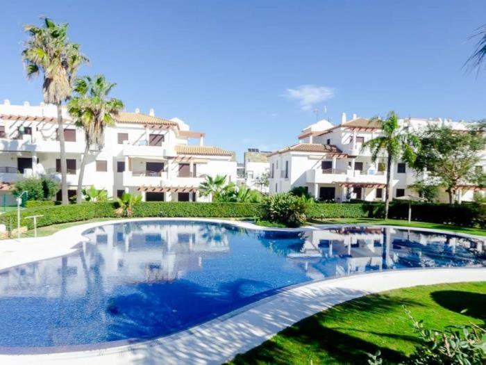 a large swimming pool in front of a building at Smart La Barrosa in Novo Sancti Petri