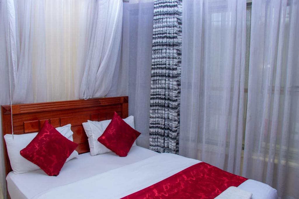 Postel nebo postele na pokoji v ubytování Epitome Times Hotel