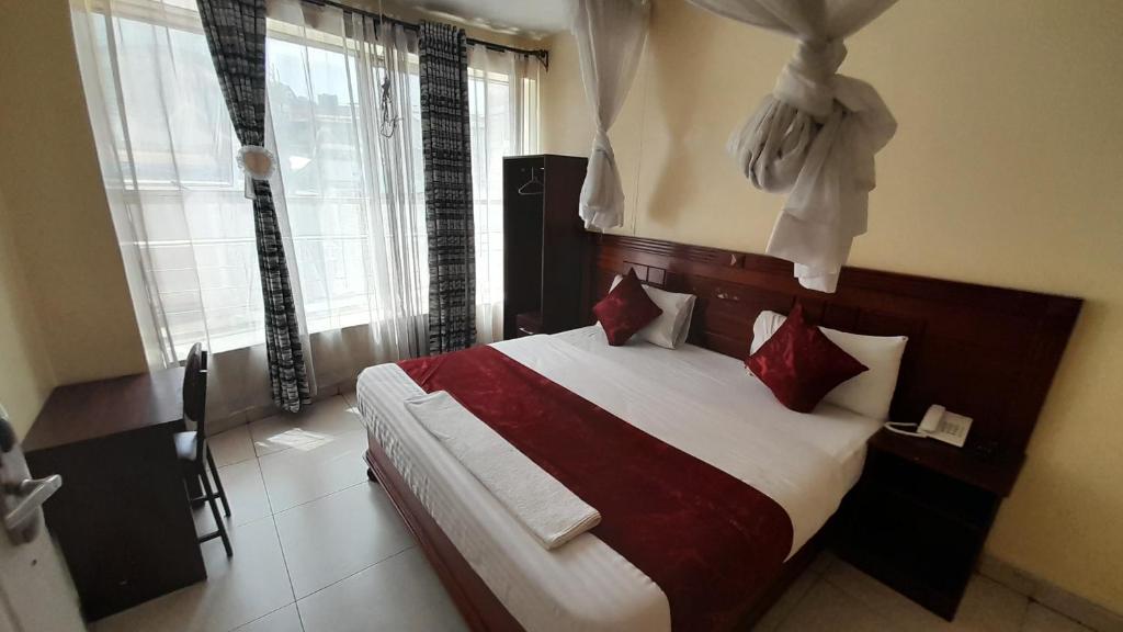Postel nebo postele na pokoji v ubytování Epitome Times Hotel