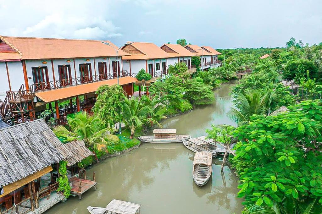 an aerial view of a river with houses and boats at Rạch sao eco garden in Phong Ðiền