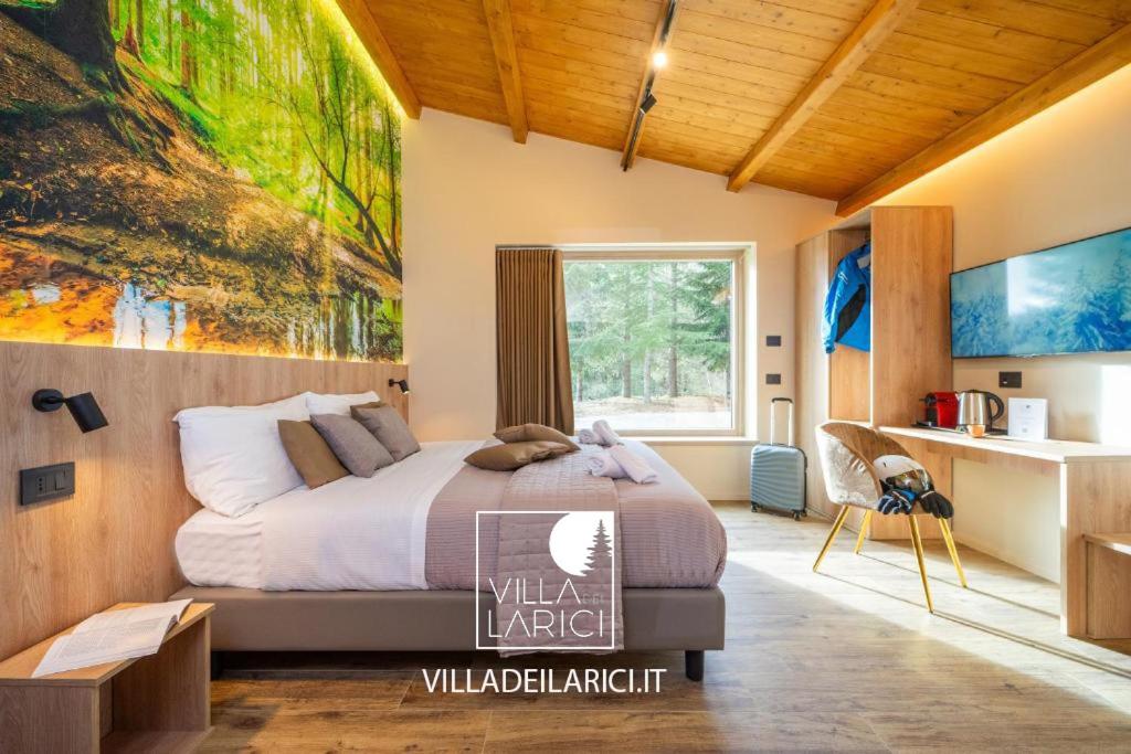 a bedroom with a bed and a painting on the wall at Villa dei Larici in Camigliatello Silano