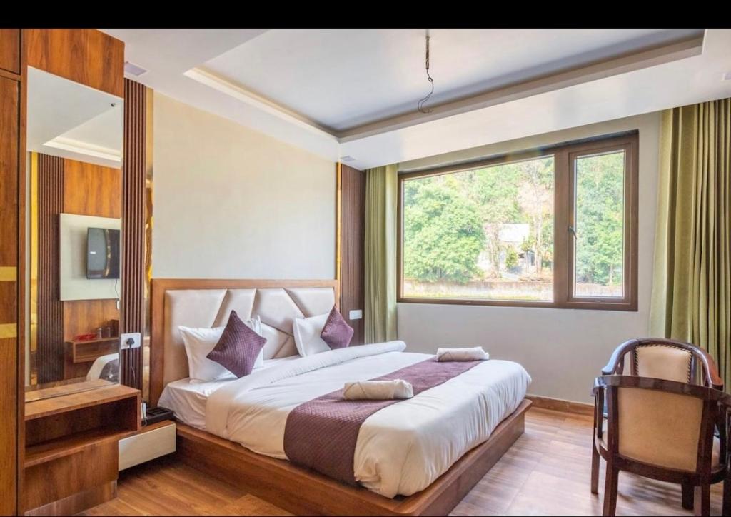 En eller flere senger på et rom på Hotel Vimal Ganga