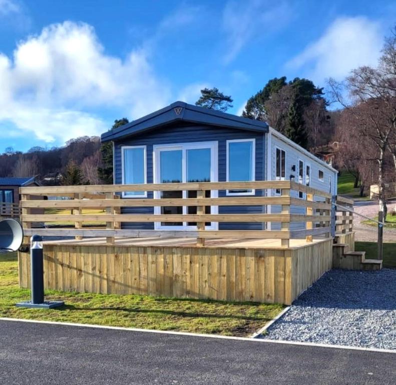 a modular home with a wooden fence at 100 Grantown in Grantown on Spey