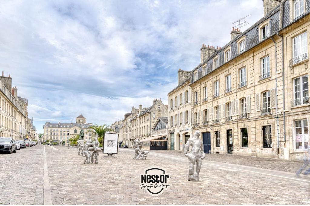 a group of statues on a city street with buildings at La Casa Will - Family flat for 8 in Hérouville-Saint-Clair