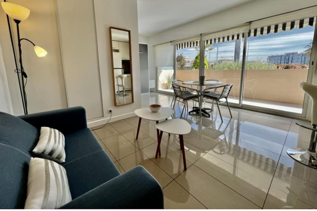 un salon avec un canapé bleu et une table dans l'établissement Studio Cresp Palm Beach, à Cannes