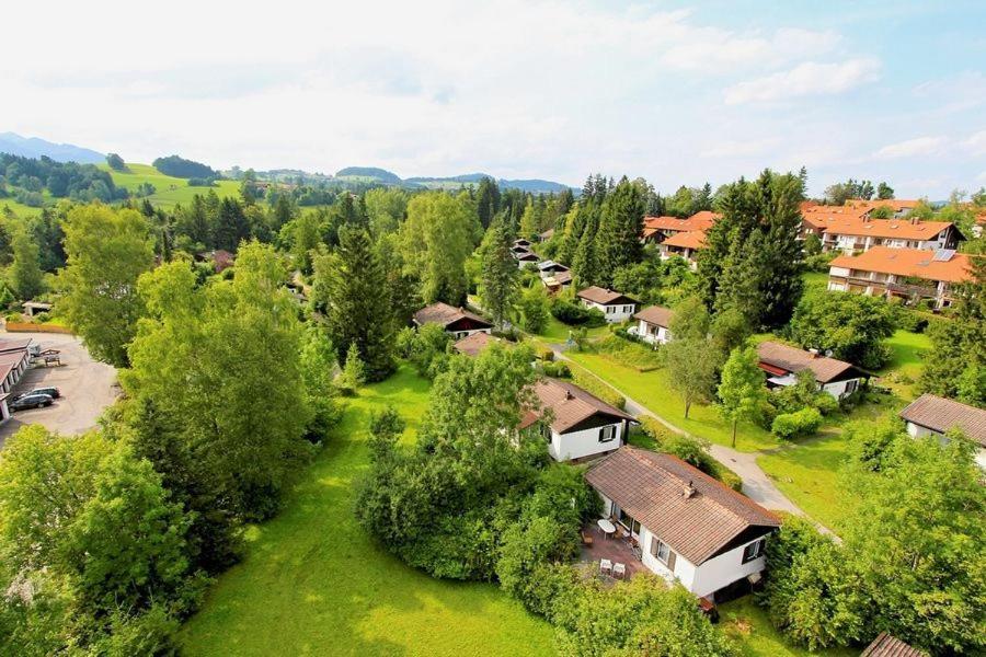 - une vue sur un village avec des maisons et des arbres dans l'établissement Ferienhäuser im Feriendorf Weissensee im Allgäu F1, à Hafenegg