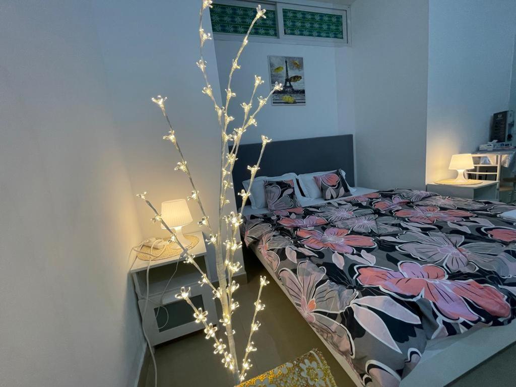 a bedroom with a bed with lights on it at Private Cozy Furnished Studio no 14 Khalidiya Park Villa Abu Dhabi UAE in Abu Dhabi