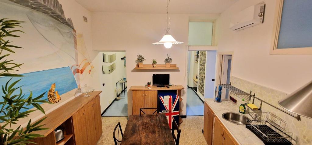a room with a kitchen with a sink and a desk at La stella di Manarola- Bluchalet in Manarola