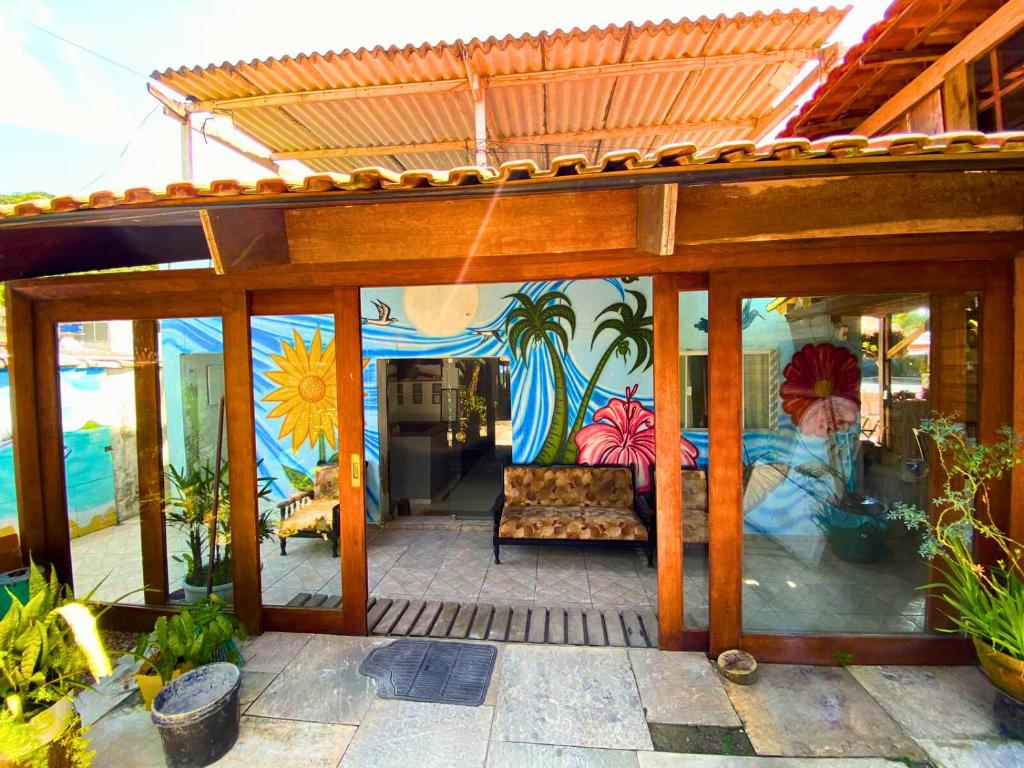 a patio with a couch and a painting on the wall at Restaurante e Pousada - Ilha Bonita in Guarujá