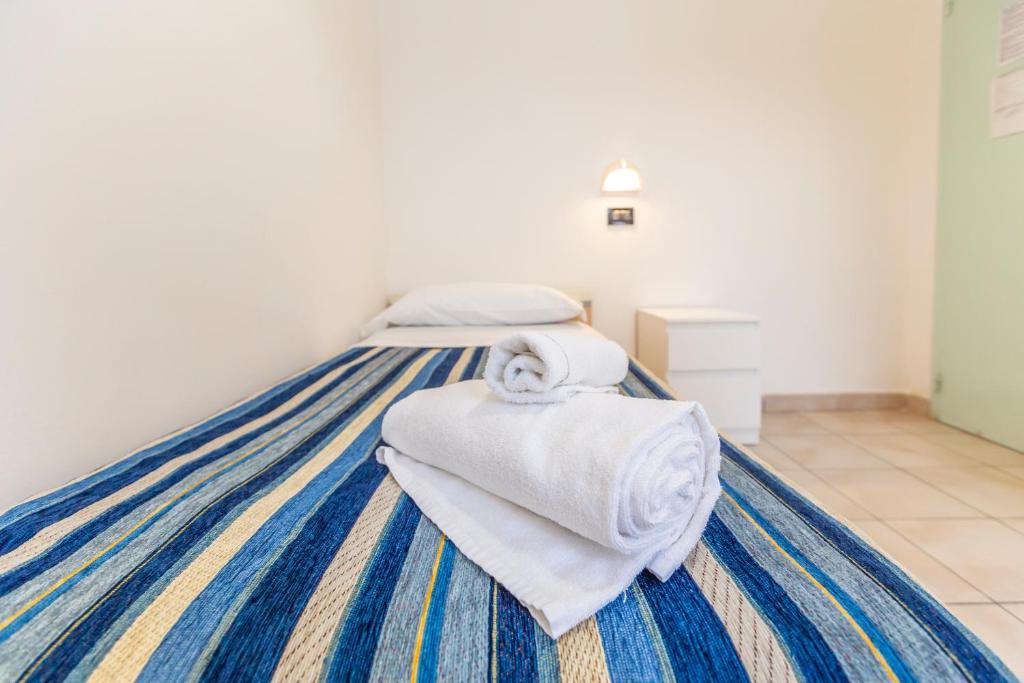 Postel nebo postele na pokoji v ubytování Hotel Vannucci