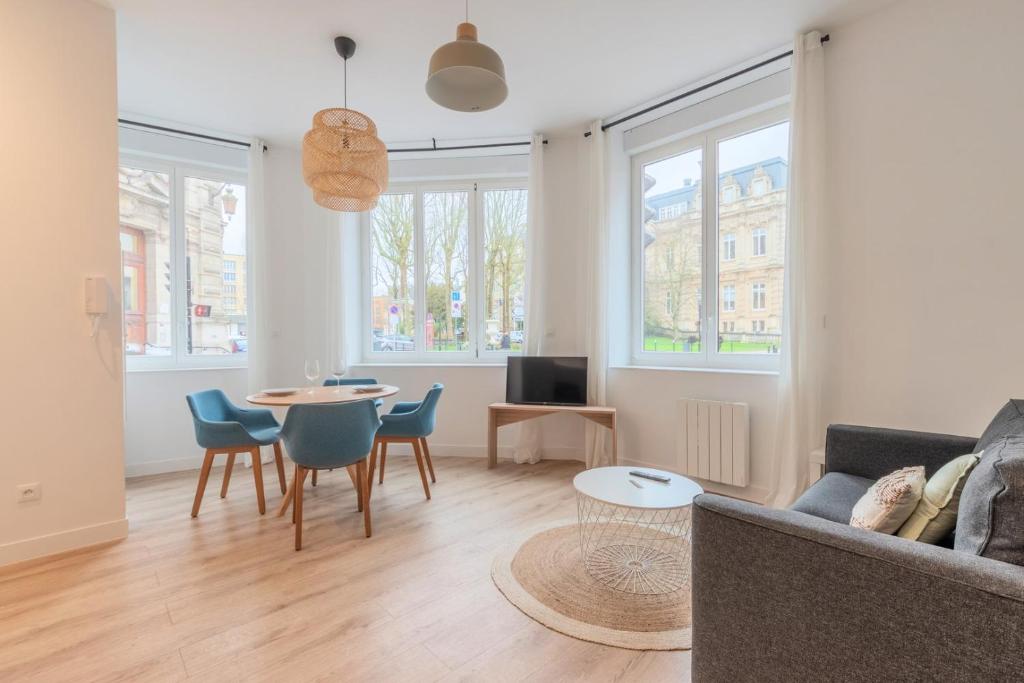 a living room with a couch and a table at One bedroom apartment with parking, city center in Tourcoing
