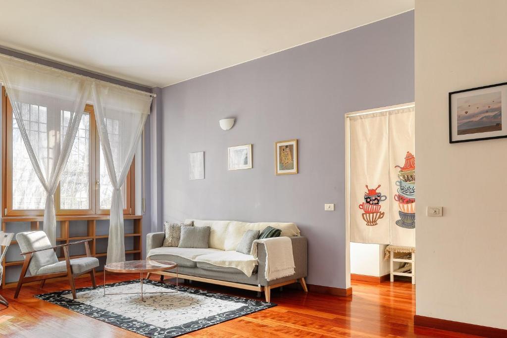 a living room with a couch and a table at Ample Apartment with private parking in Milan