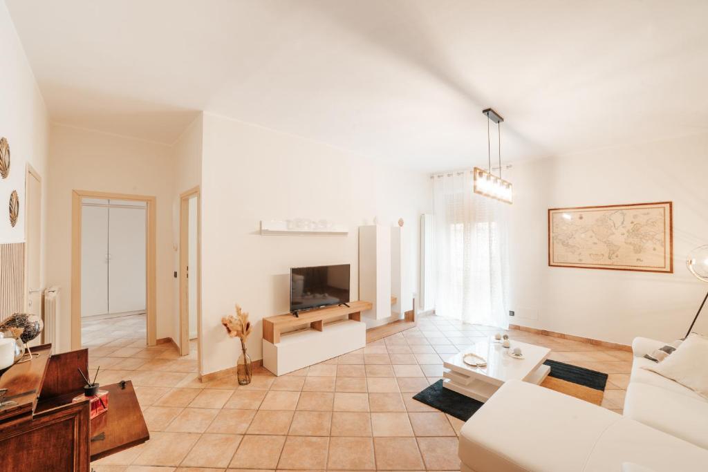 ein Wohnzimmer mit einem weißen Sofa und einem TV in der Unterkunft CR32 TOURIST ACCOMODATION in Civitavecchia