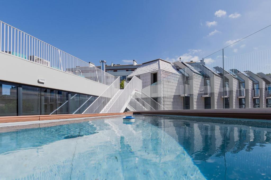 a swimming pool in front of a building at StudentVille Central in Lisbon