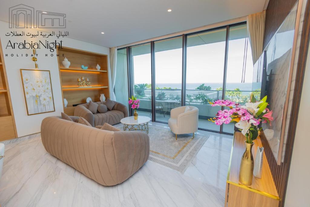 a living room with a couch and a table with flowers at Arabian Nights - Seaside Splendor Apartment at Atlantis The Royal in Dubai