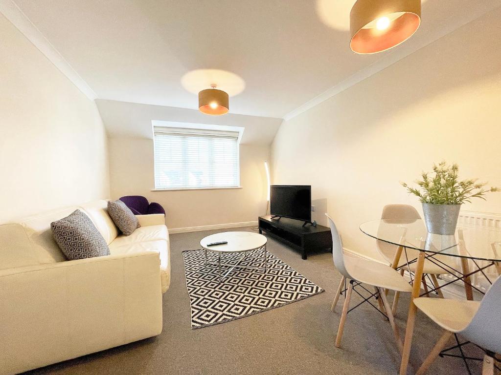 a living room with a couch and a table at Travaal.©om - 2 Bedroom Apartment - Farnborough in Farnborough