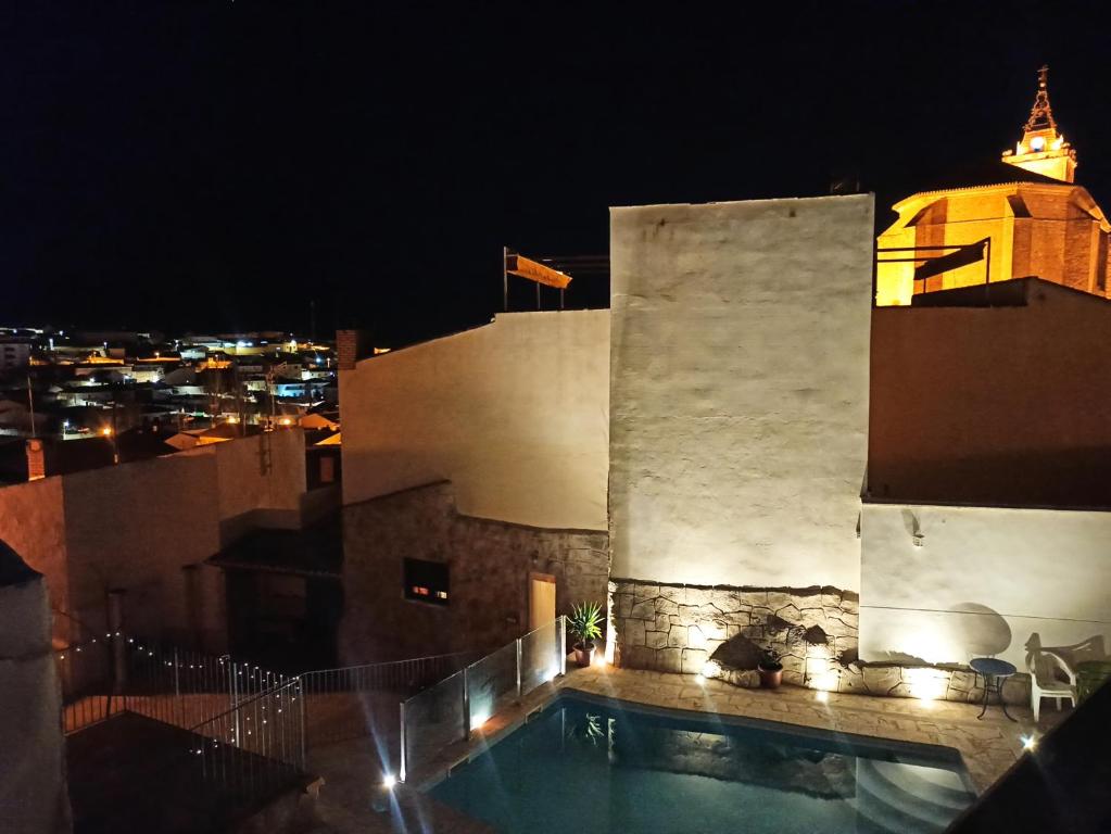un edificio con piscina por la noche en Casa Rural El Almez, en Horcajo de Santiago