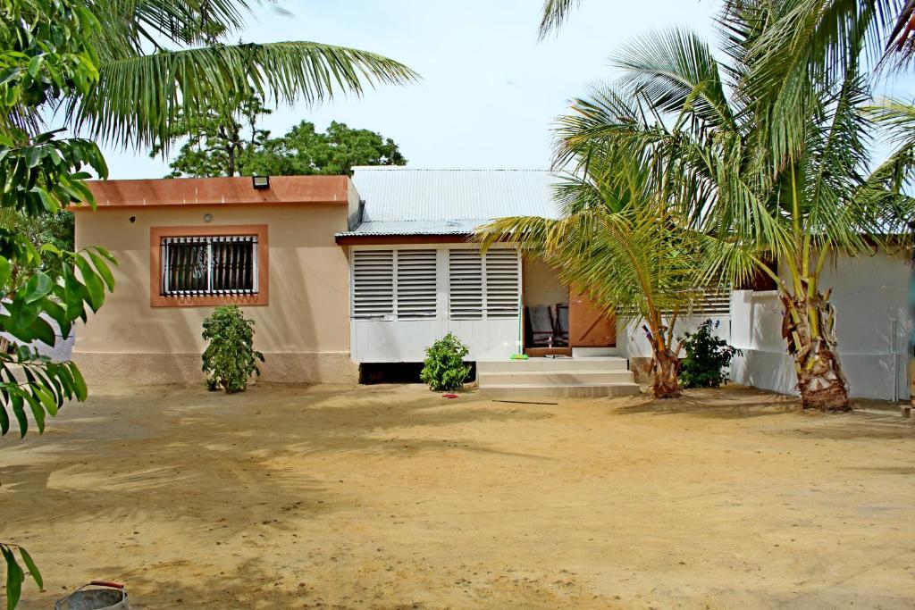 a house with a palm tree in front of it at Chambre D'hôtes Morondava in Morondava
