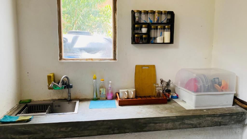 a kitchen counter with a sink and a window at Elisha Place Hiriketiya in Dickwella