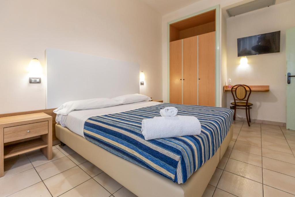Postel nebo postele na pokoji v ubytování Hotel Vannucci