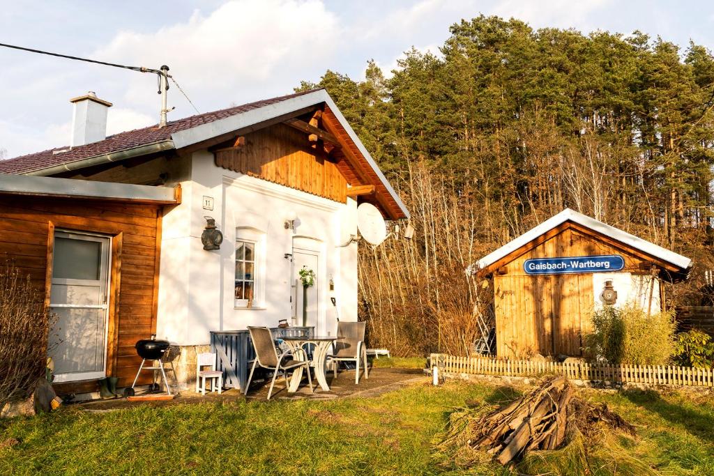 Cabaña con mesa y sillas en el patio en Bahnwärterhaus, en Pregarten