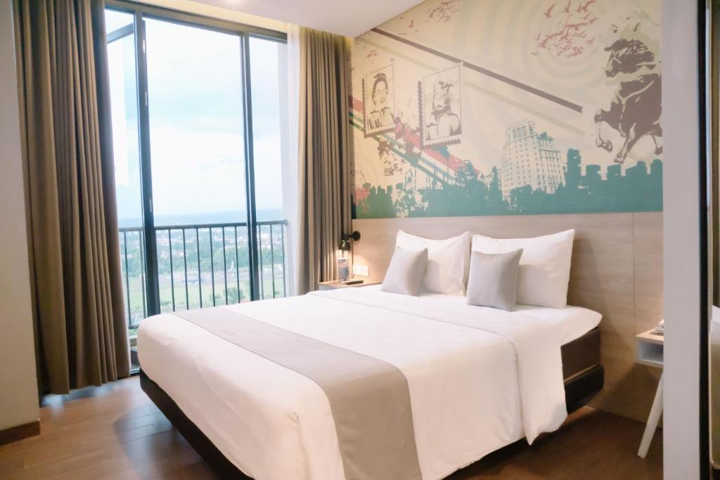 Postel nebo postele na pokoji v ubytování Hotel Fortunagrande Jember