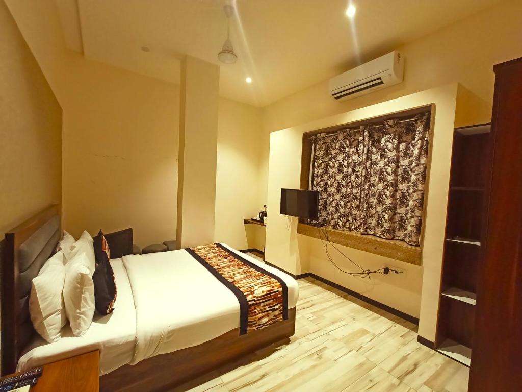 Voodi või voodid majutusasutuse Radhamangal Colors Inn toas