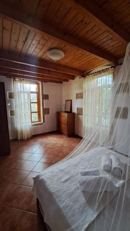 a bedroom with a bed with a mosquito net at Villa Nama in Kissamos