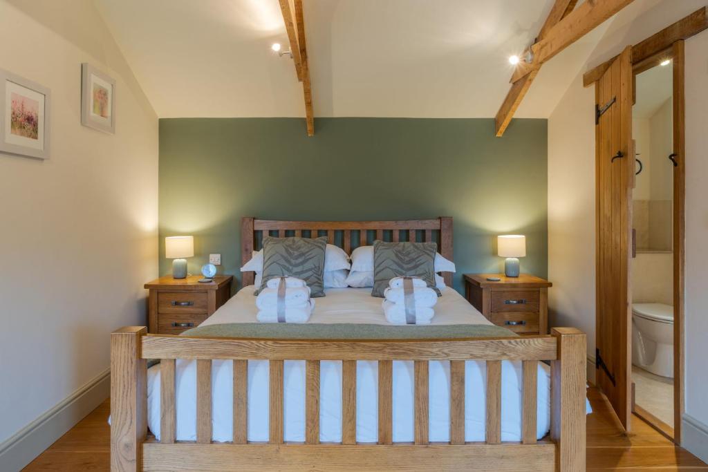 a bedroom with a large bed with two night stands at Budding in Dyrham