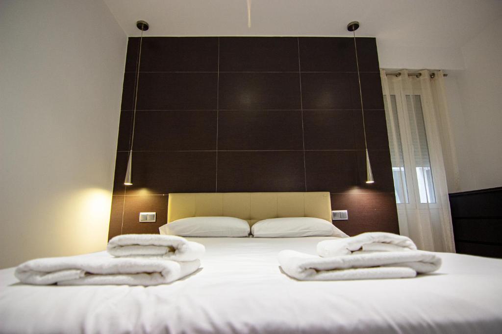 A bed or beds in a room at Apartamento amplio y luminoso a 2 min del Centro