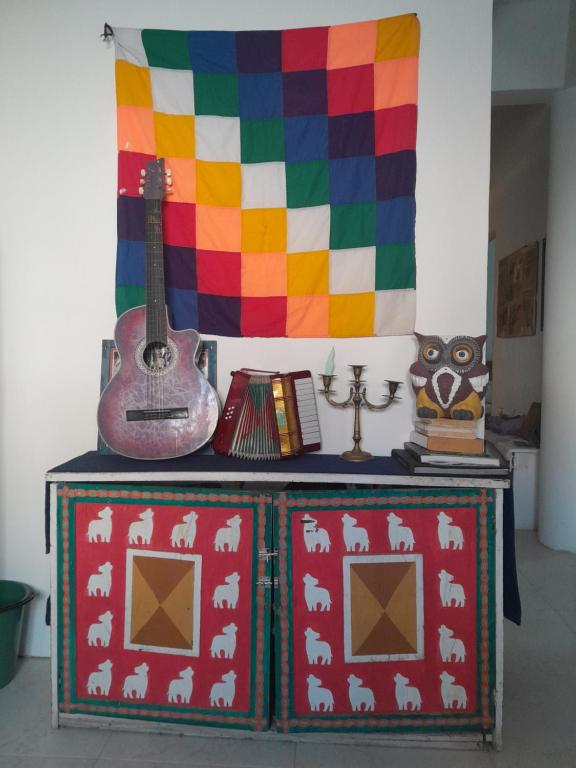 a colorful table with a guitar on top of it at Iguaque Lodge in Villa de Leyva