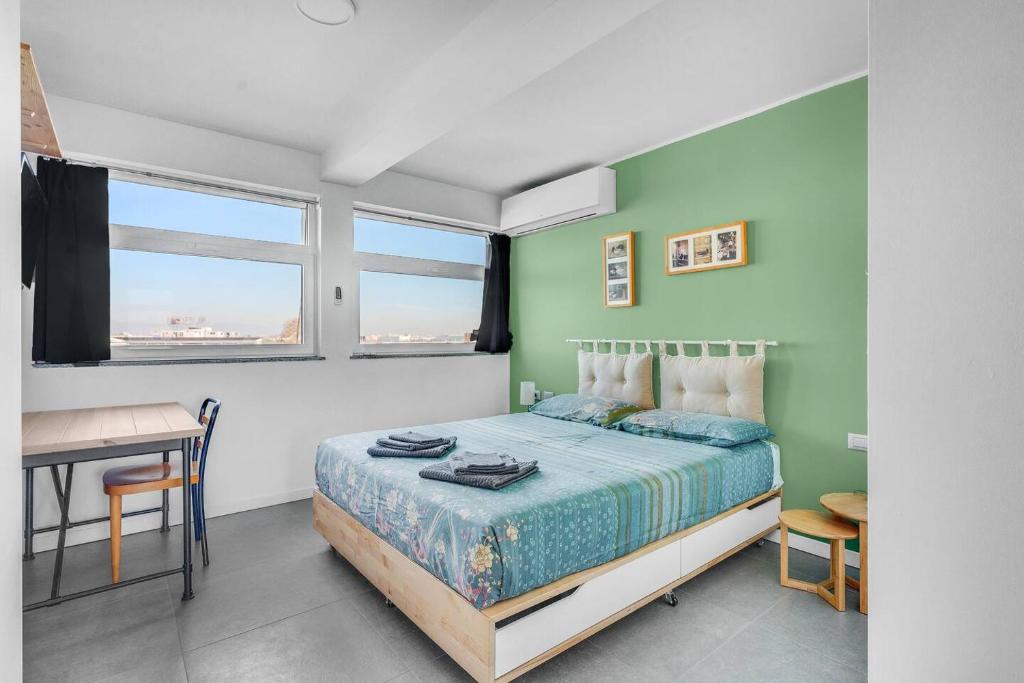 Schlafzimmer mit einem Bett, einem Schreibtisch und einem Fenster in der Unterkunft PM Via Gabriele D' Annunzio Guest House in Pero
