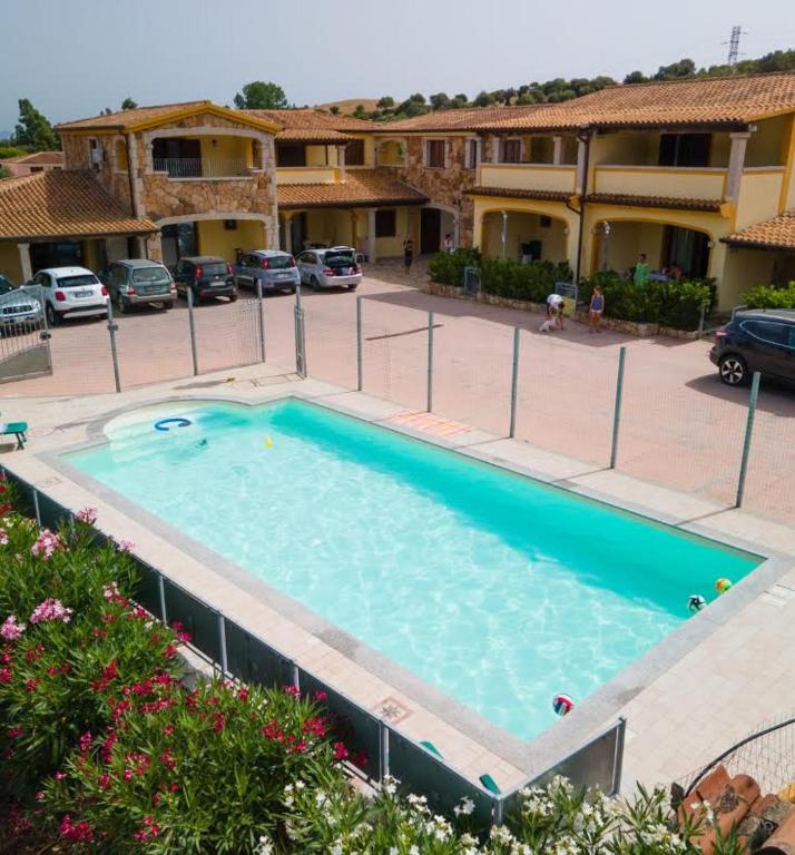 a large swimming pool in a parking lot at Angel Village in San Teodoro