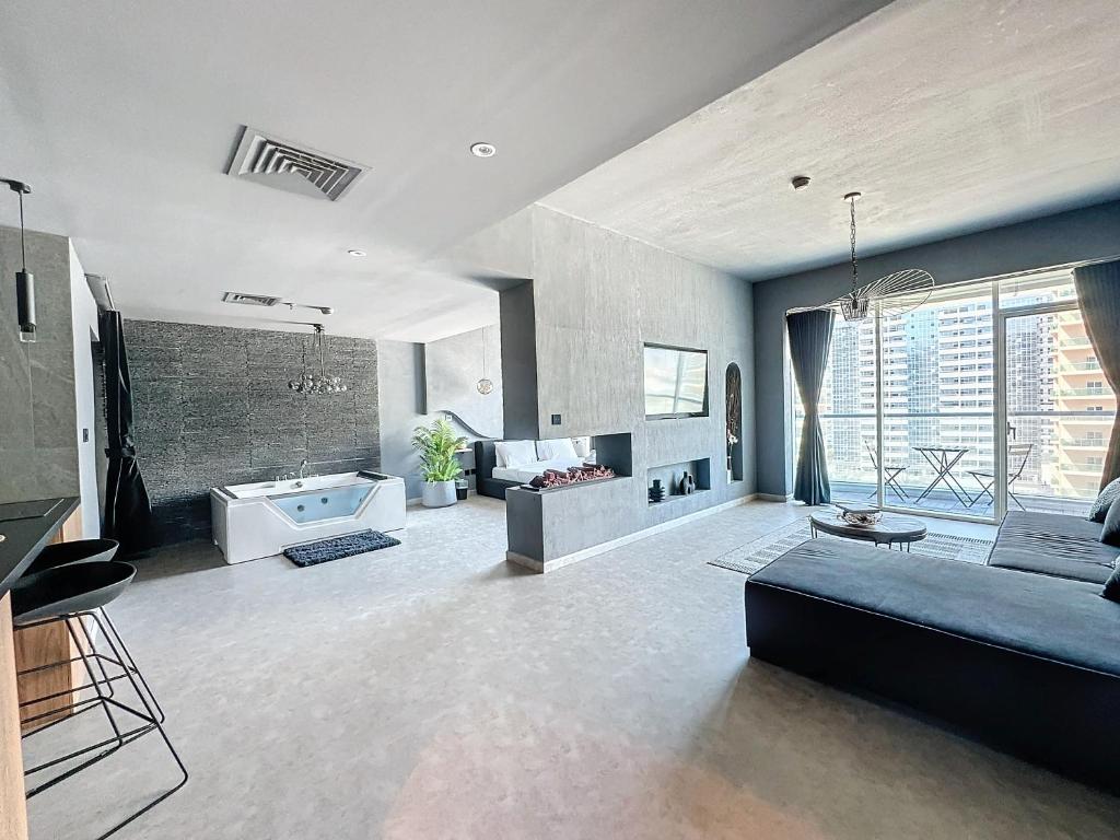 a large living room with a couch and a tub at Key View - Hub Canal 1 in Dubai