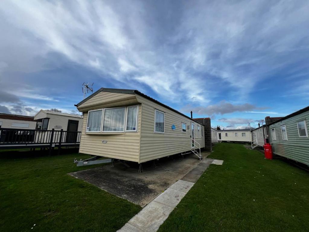 a tiny house is parked in a yard at 6 Berth Staycation Caravan Nearby Clacton-on-sea In Essex Ref 26254e in Clacton-on-Sea