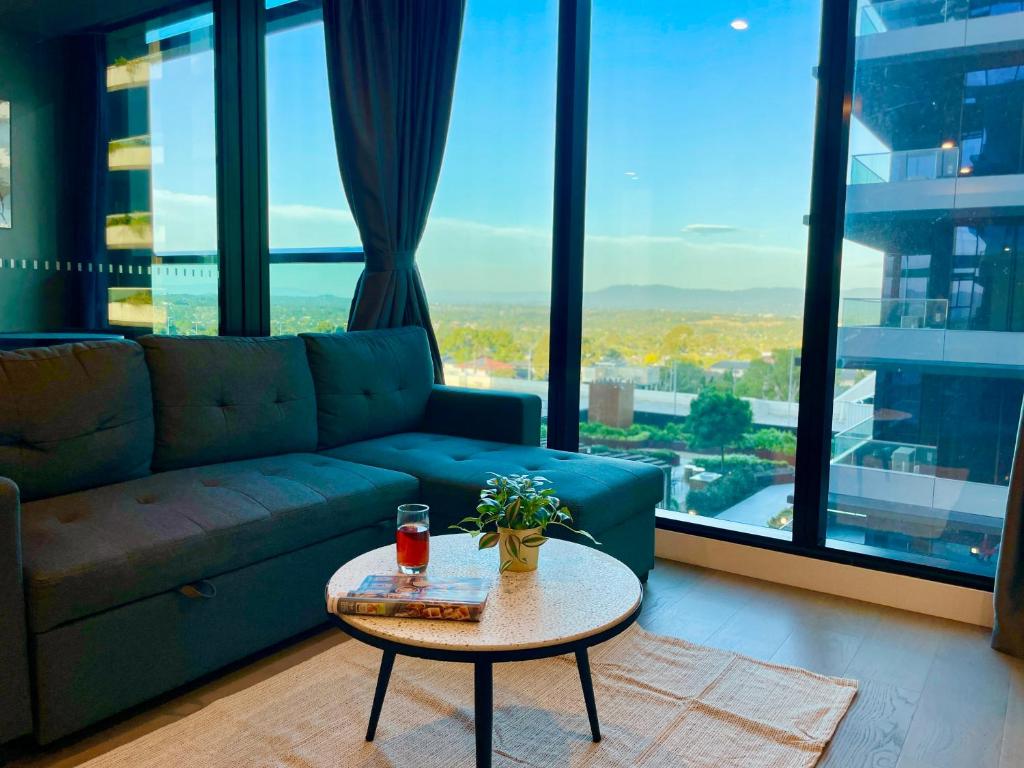 a living room with a couch and a coffee table at Skygarden On The Glen in Glen Waverley