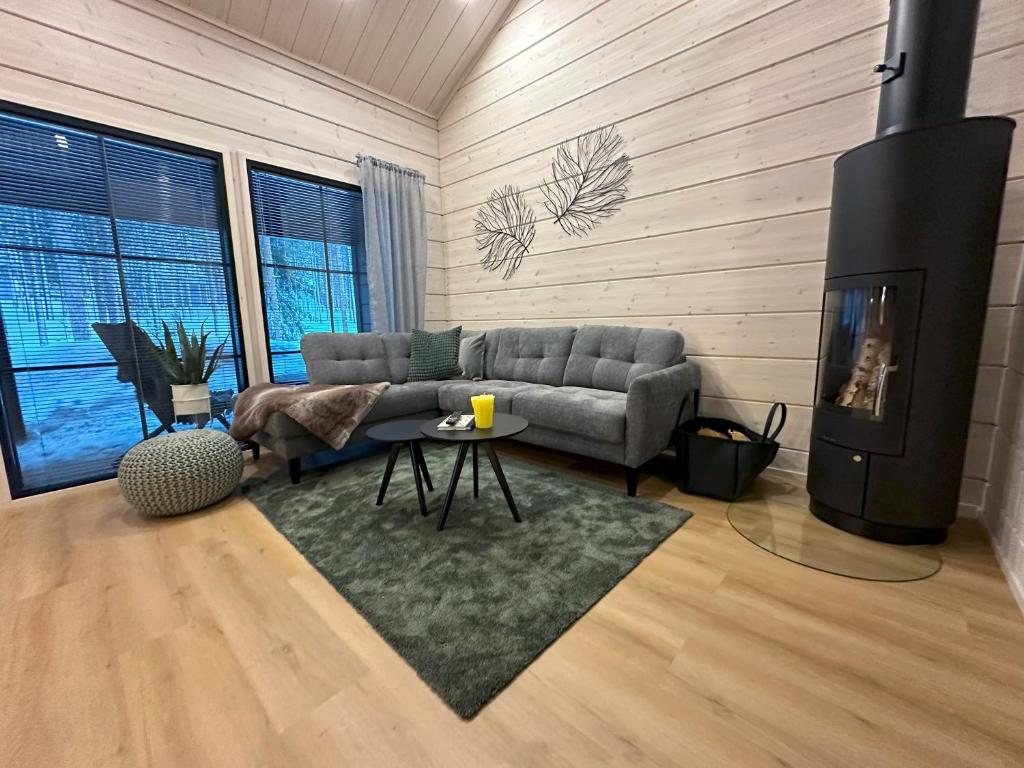 a living room with a couch and a table at Yläkasi in Kittilä