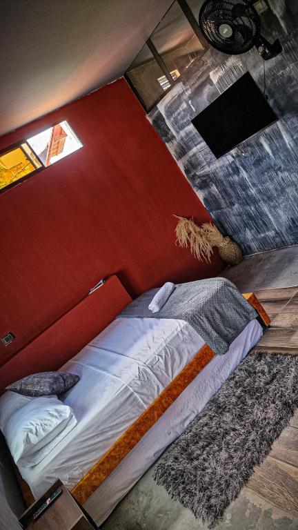 Una cama o camas en una habitación de Urban Hostal San Gil- Piscina Restaurante Bar