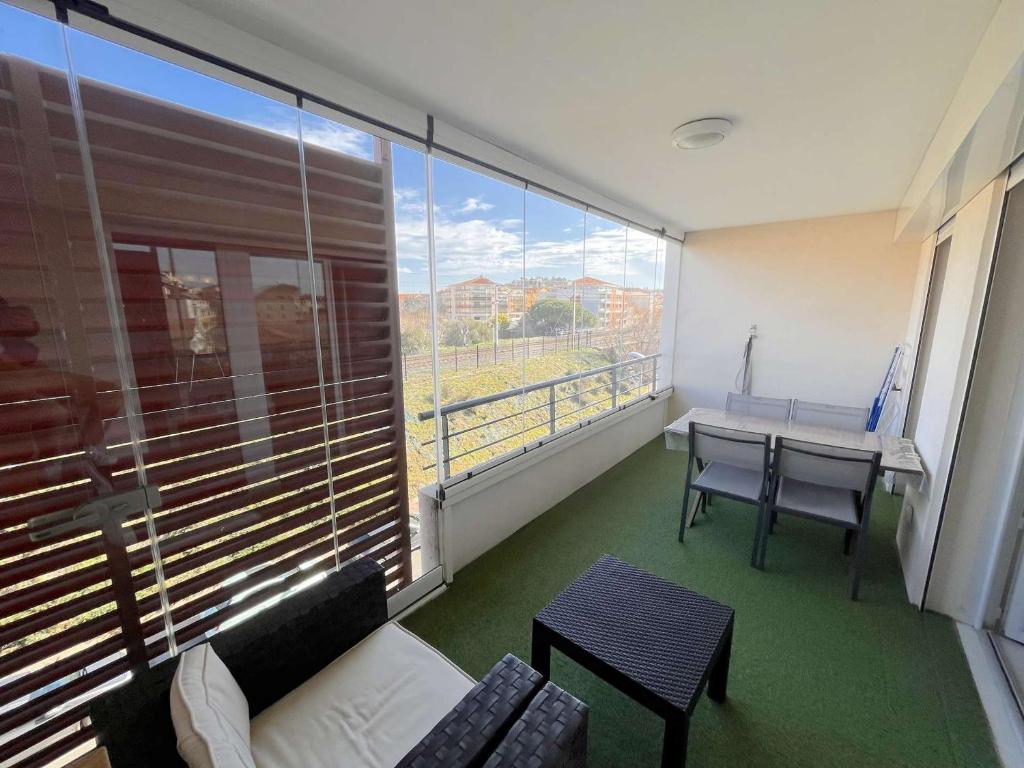 a room with a couch and a table and a large window at Appartement Saint-Raphaël, 3 pièces, 4 personnes - FR-1-226A-274 in Saint-Raphaël