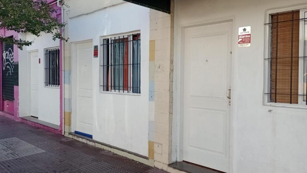 rząd białych drzwi na budynku w obiekcie Sencillo y cálido Monoambiente en S Fernando w mieście San Fernando