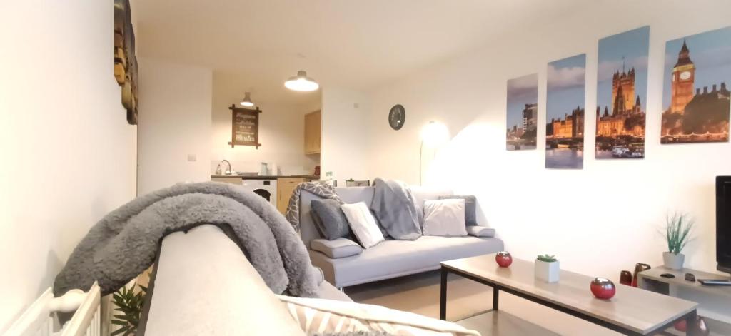 a living room with a couch and a table at 2 Bed Crawley Apt - Near Gatwick in Crawley