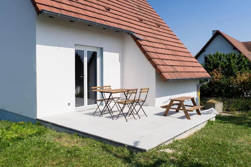 a table and chairs on a porch of a house at Maison à la campagne 6 personnes in Zutzendorf