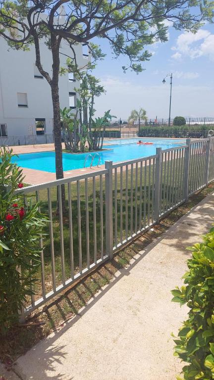 a fence in front of a swimming pool at Golf Las Terrazas de La Torre LRVDM House in Roldán