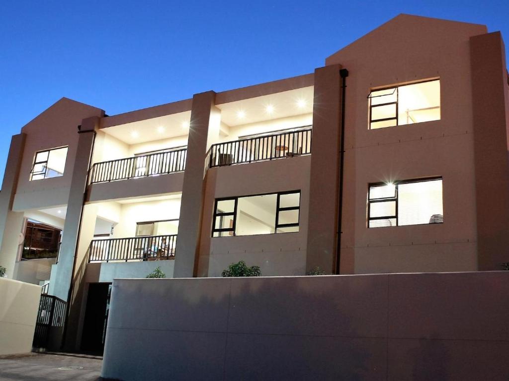 a large brick building with lights on at LêPlek Guesthouse in Saldanha