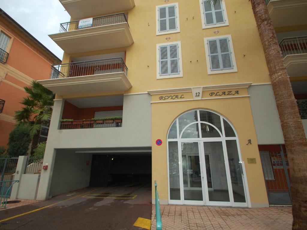 a large yellow building with a door and balcony at Appartement Menton, 2 pièces, 4 personnes - FR-1-196-336 in Menton