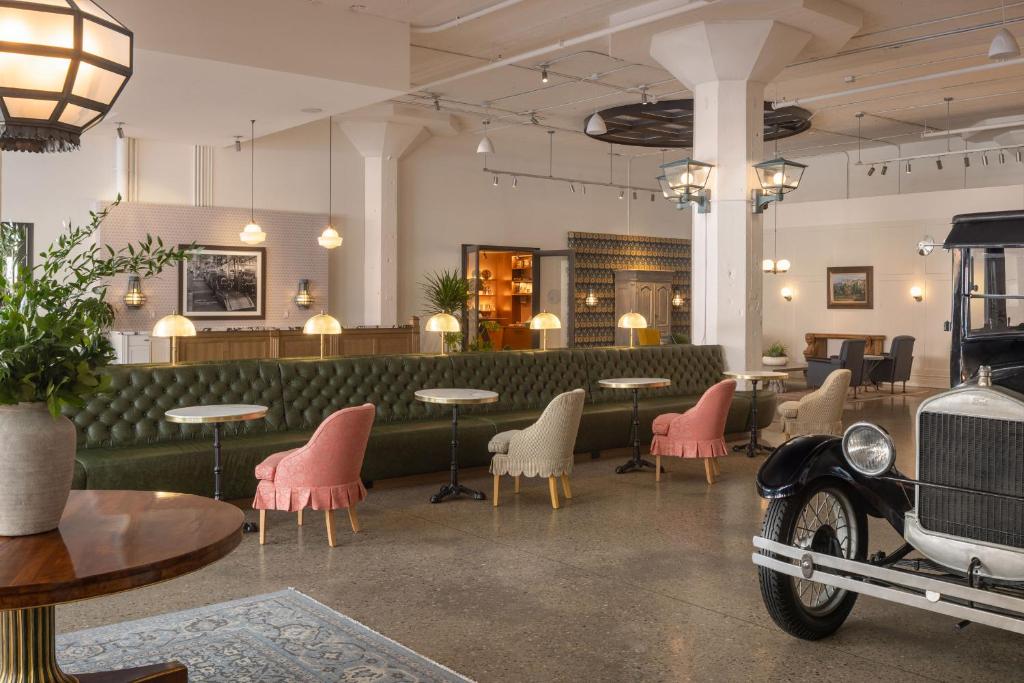 an old car parked in a restaurant with tables and chairs at Fordson Hotel, in the Unbound Collection by Hyatt in Oklahoma City