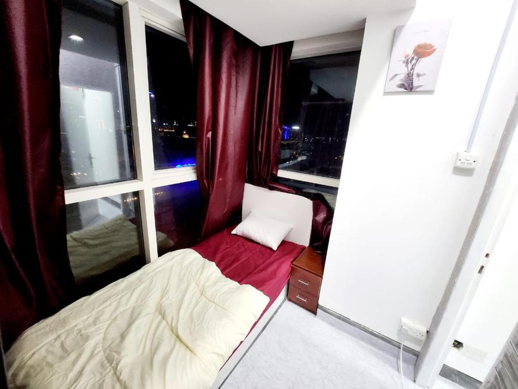 a small bed in a room with a window at Panoramic Partation with Amazing View close to Mall Of Emirates in Dubai