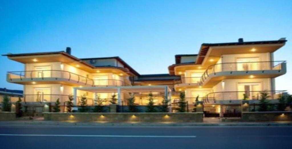 a large building with lights on the side of it at Ammolithos Beach in Stavros